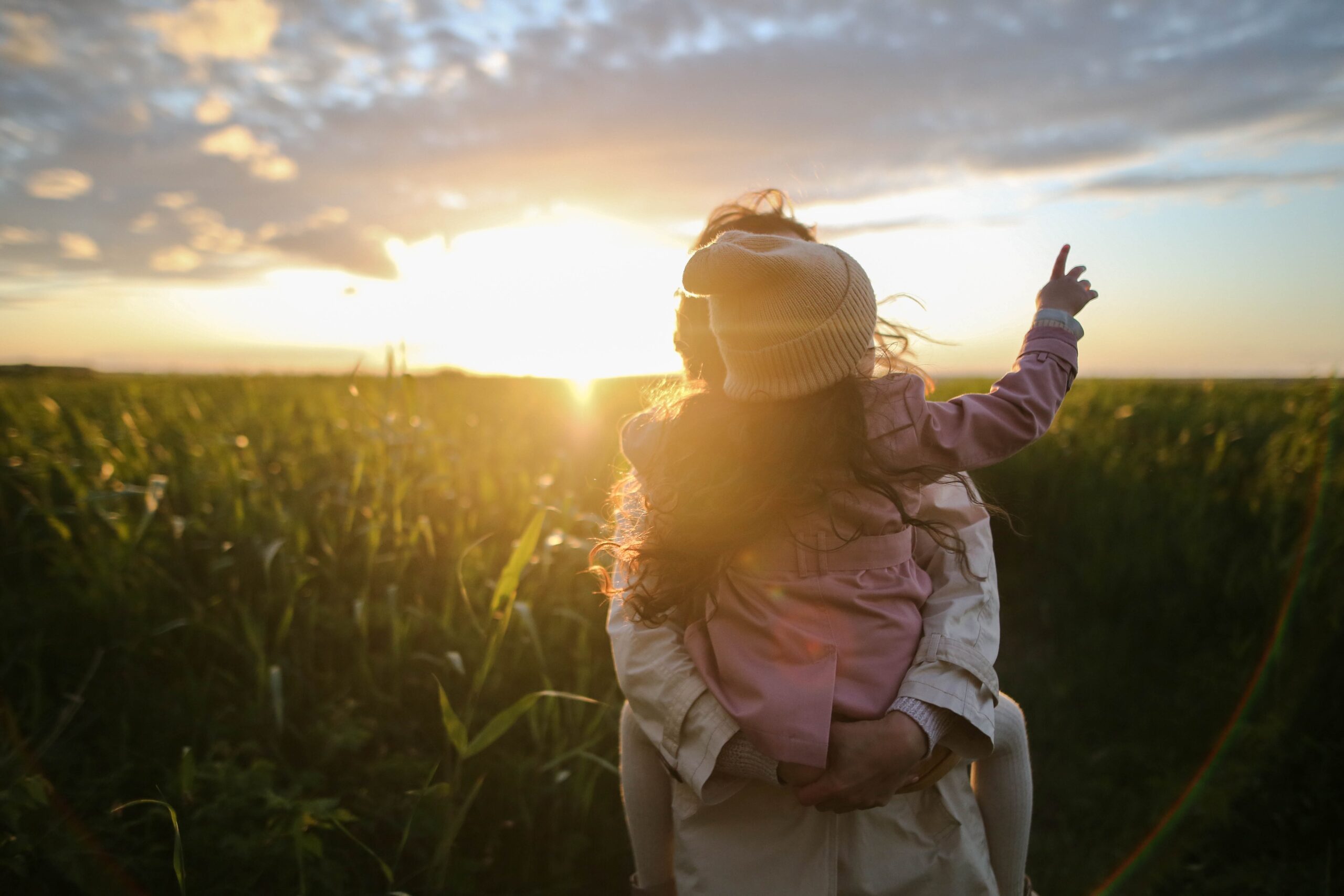 Sunlight / sunset behind the head of mother carrying child