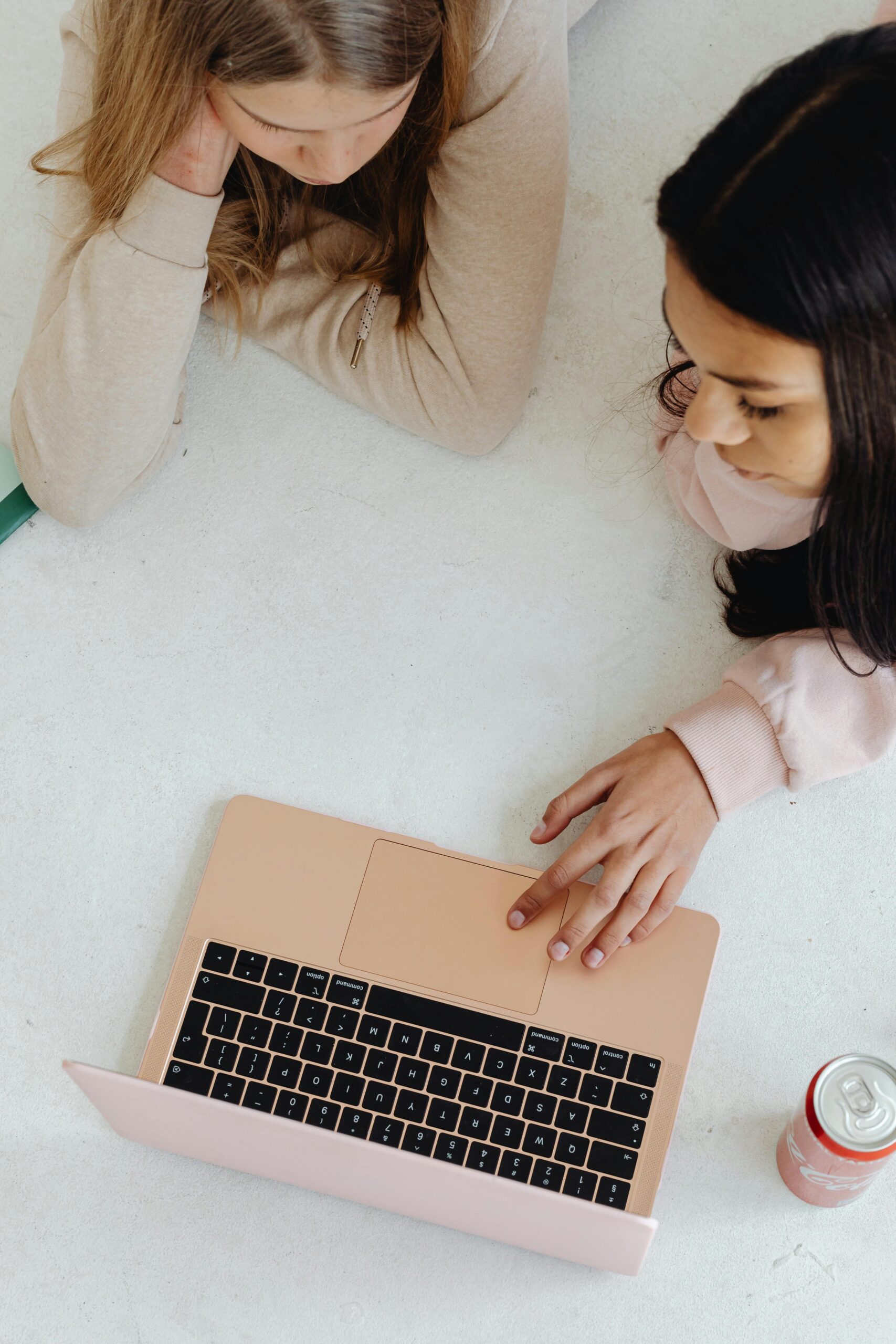 2 girls looking at laptop